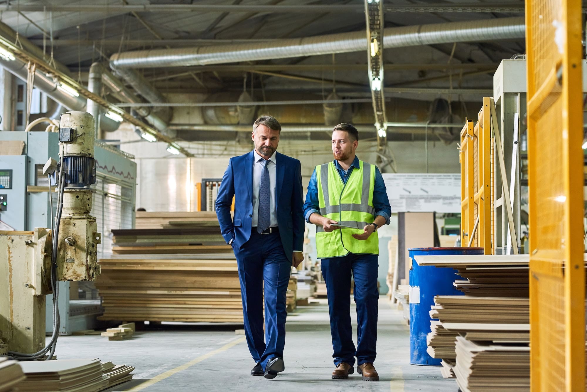 Mature Businessman Inspecting Modern Factory